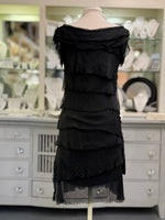 Back view of the Gianna short Italian silk dress in black at Ardor Boutique, showing flowing asymmetrical silk tiers and a sheer layered hem.