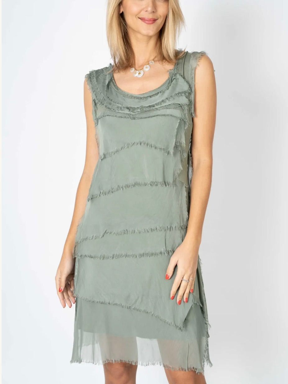 Model wearing the Gianna Italian silk dress in olive from Ardor Boutique, featuring a sleeveless scoop neckline, flowing silk layers, and a shorter hem.