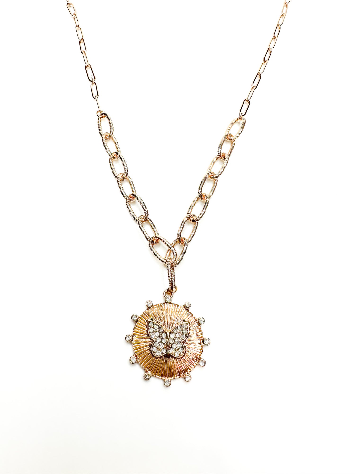 Gold necklace with a shell pendant on a white background