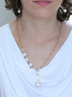 Model wearing the Grace Pearl NH Necklace from Ardor Boutique, showcasing its asymmetrical matte gold chain, freshwater pearls, and baroque pearl drop.
