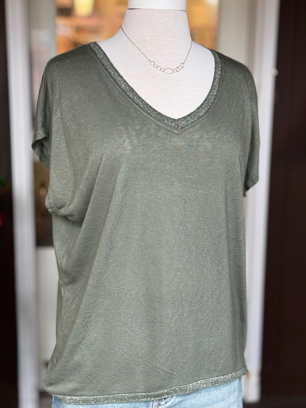 Grace Batwing Short Sleeve Top in olive with a relaxed fit, V-neckline and silver sparkle trim at the neckline and hem at Ardor Boutique.