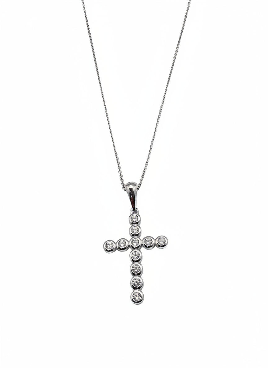 close up of sterling silver cross necklace with sparkling stones from Ardor Boutique