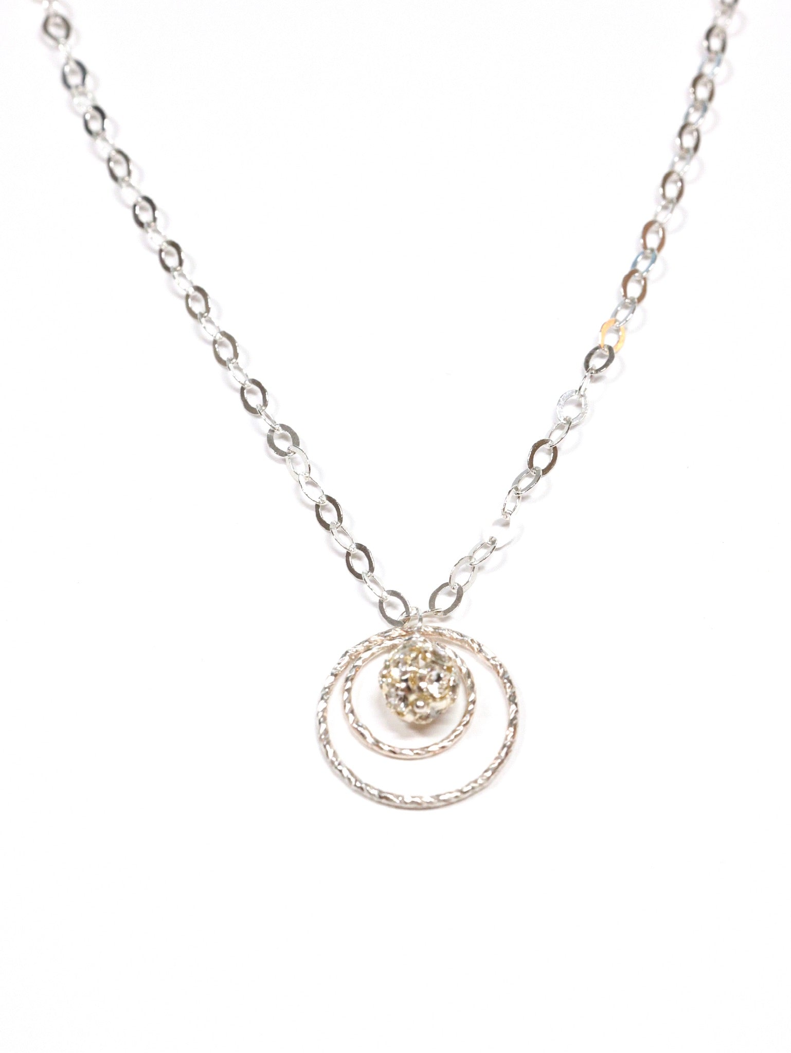 A sterling silver necklace with a swirled design pendant and a clear crystal drop in the center, displayed against a white background.