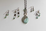 Jewelry set with a necklace and earrings on a light background