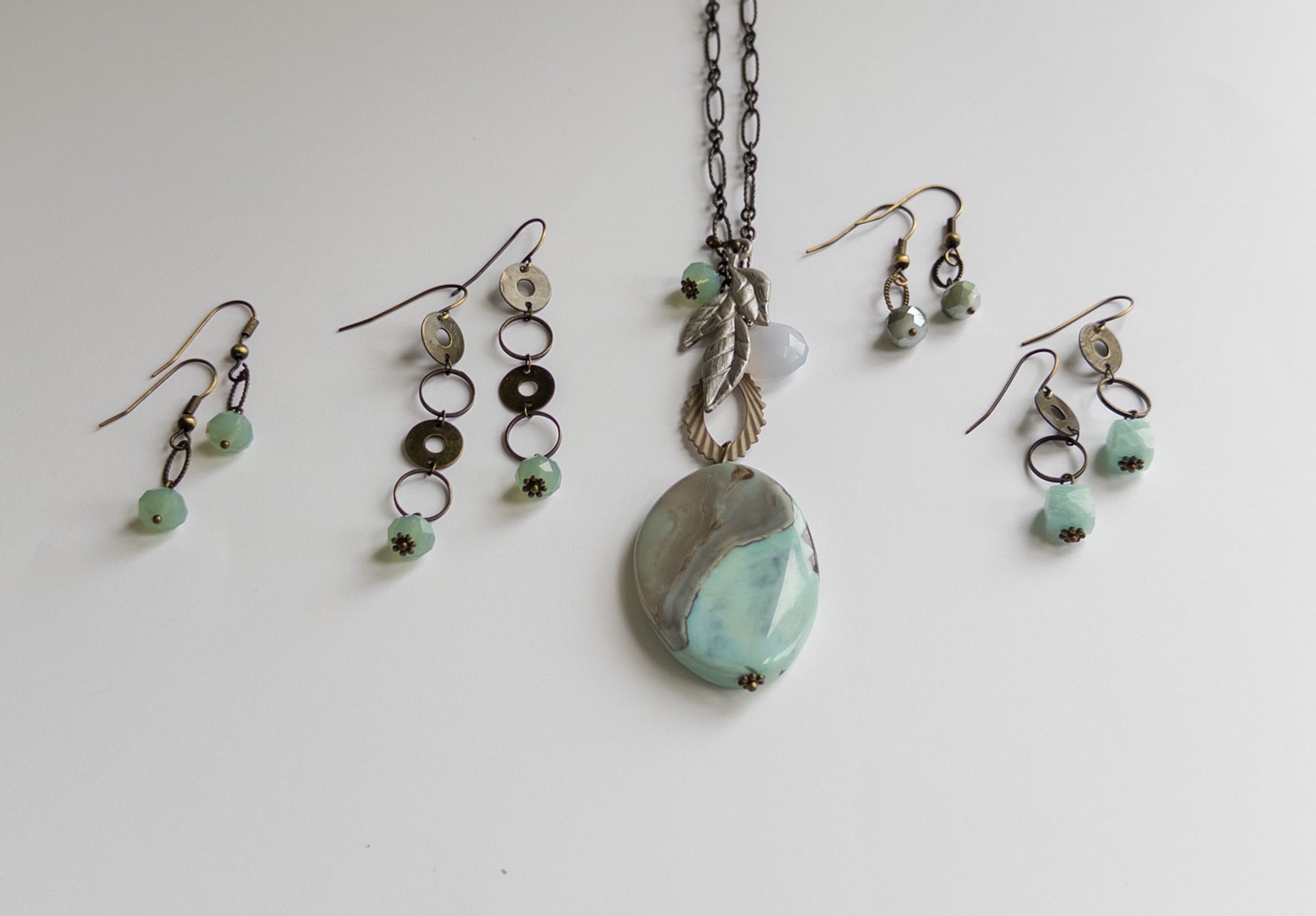 Jewelry set with a necklace and earrings on a light background