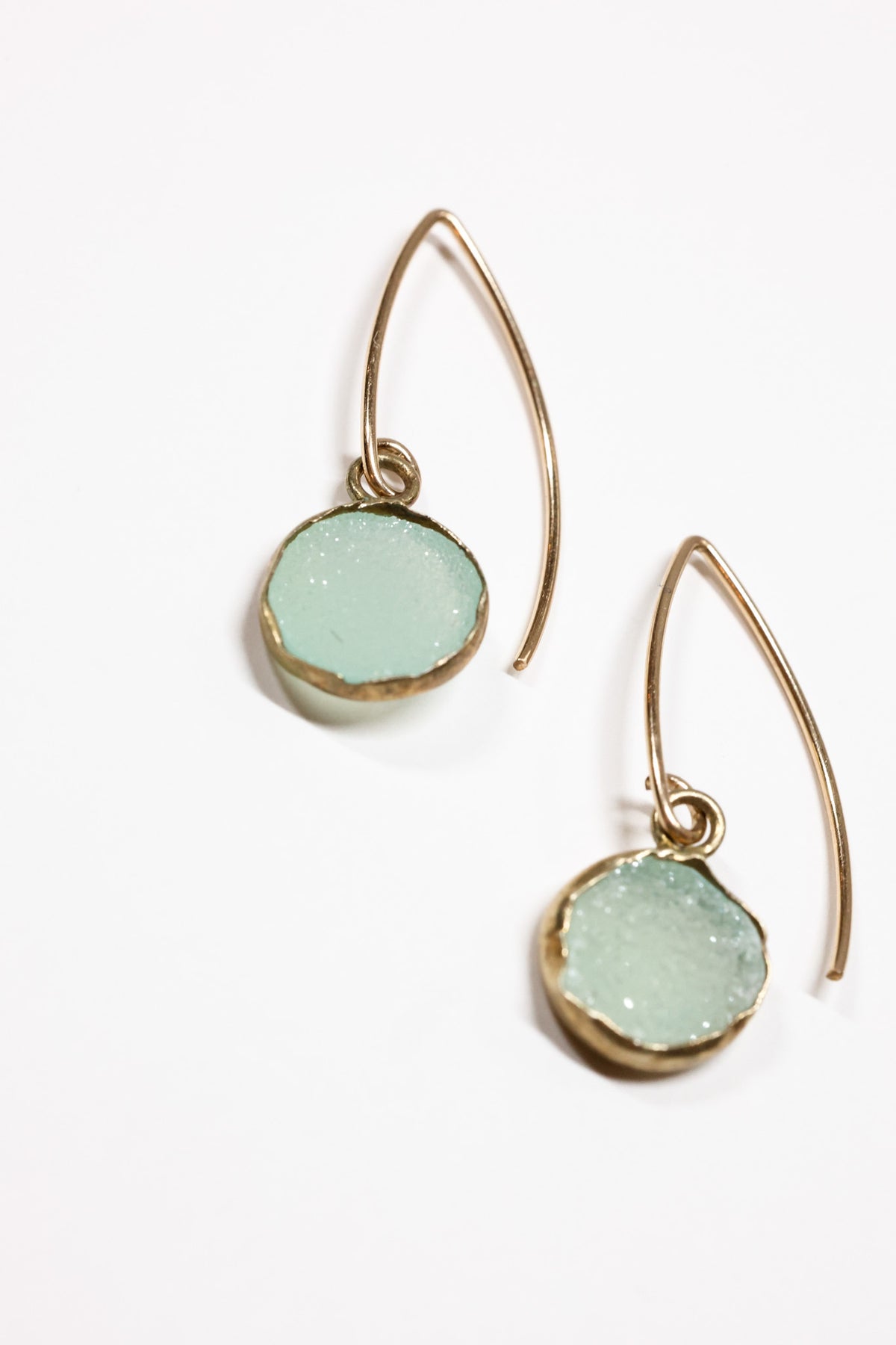 Leya Aqua Druzy round drop earrings on flat lay 