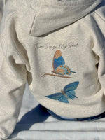 Oatmeal hoodie with butterfly design and text on a neutral background
