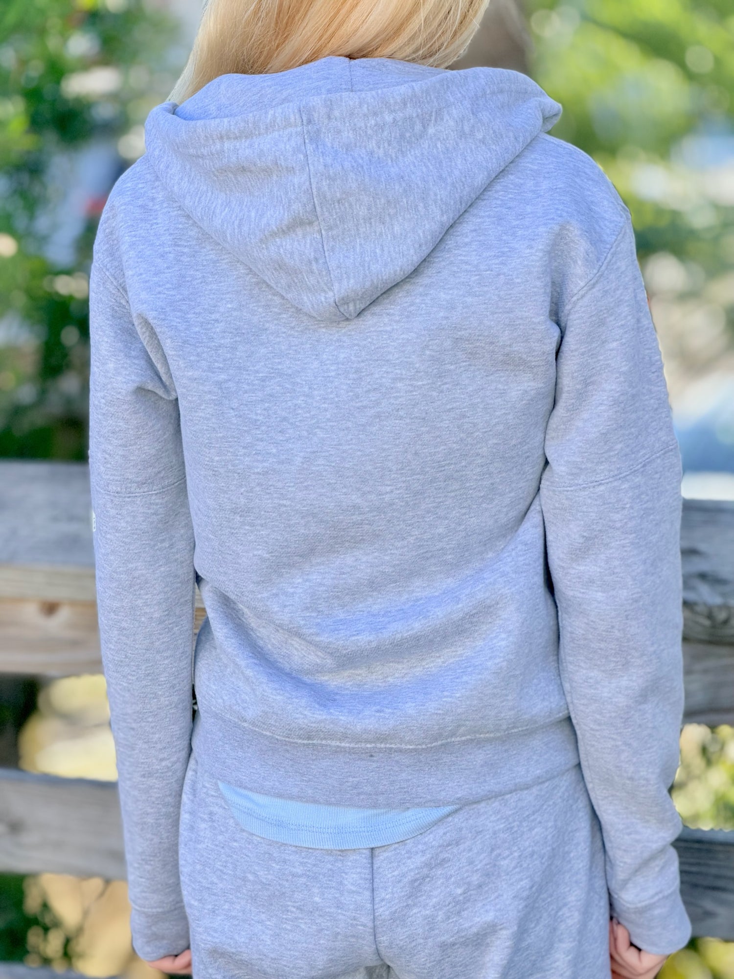 Women’s butterfly Zip-up hoodie with chest butterfly graphic, butterfly sleeve design, drawstring hood and ribbed trim at Ardor Boutique.