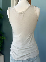 Beige tank top on a mannequin with a blurred background