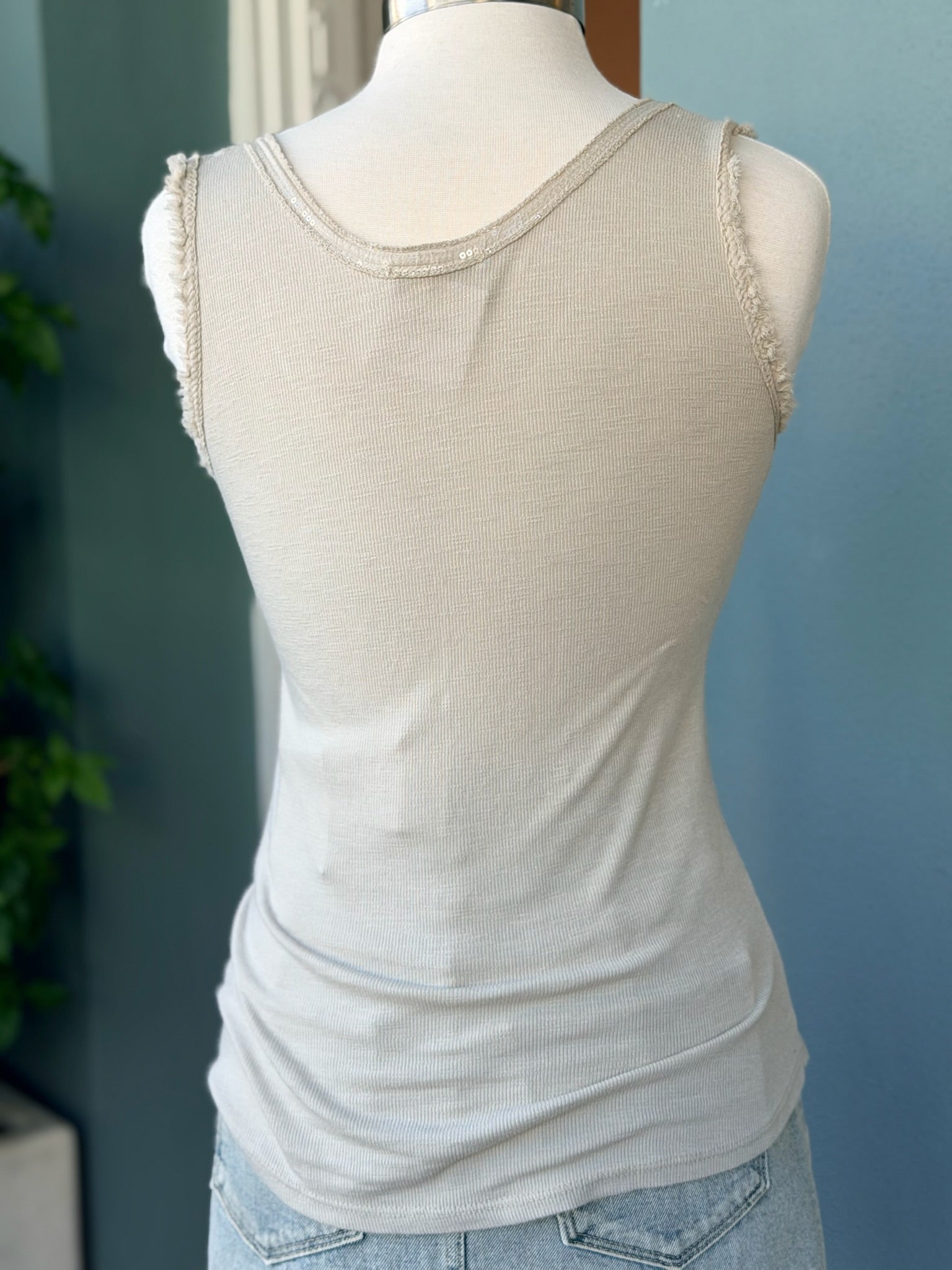 Beige tank top on a mannequin with a blurred background