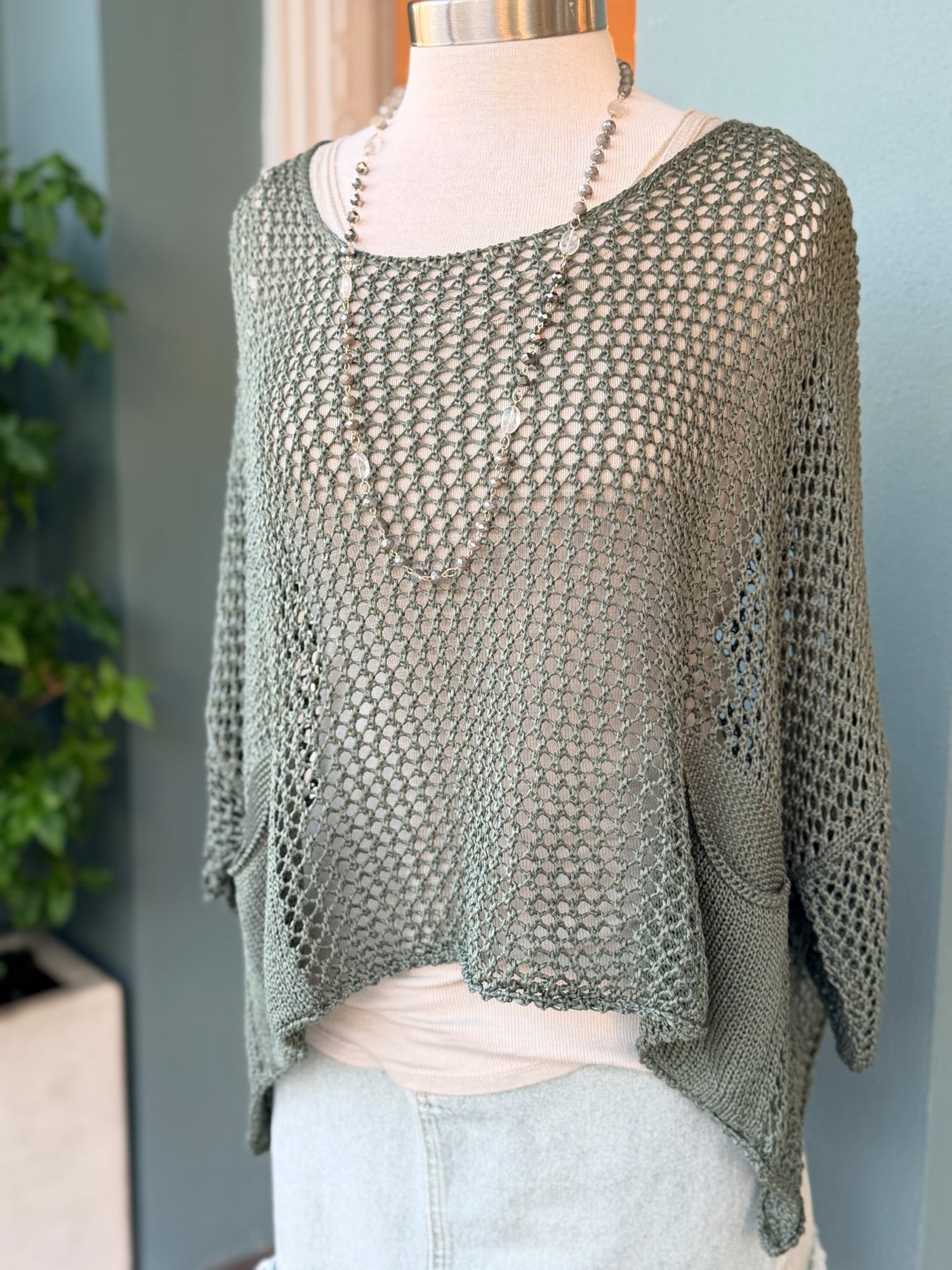 Knitted sweater on a mannequin against a neutral background