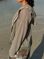 Side profile of the taupe Gia Mesh Hooded Jacket highlighting the open-knit texture, draped hood, and relaxed sleeves.
