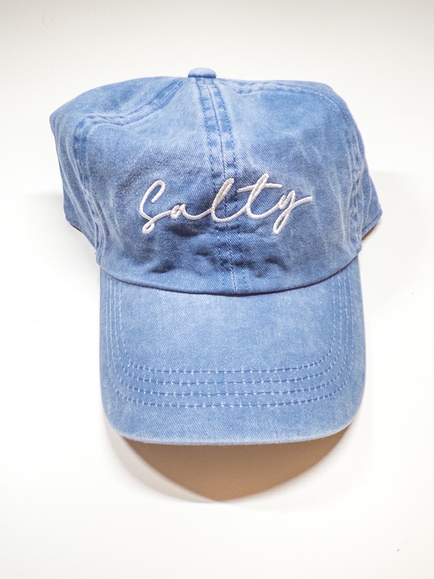 Blue cap with 'Salty' embroidery on a white background