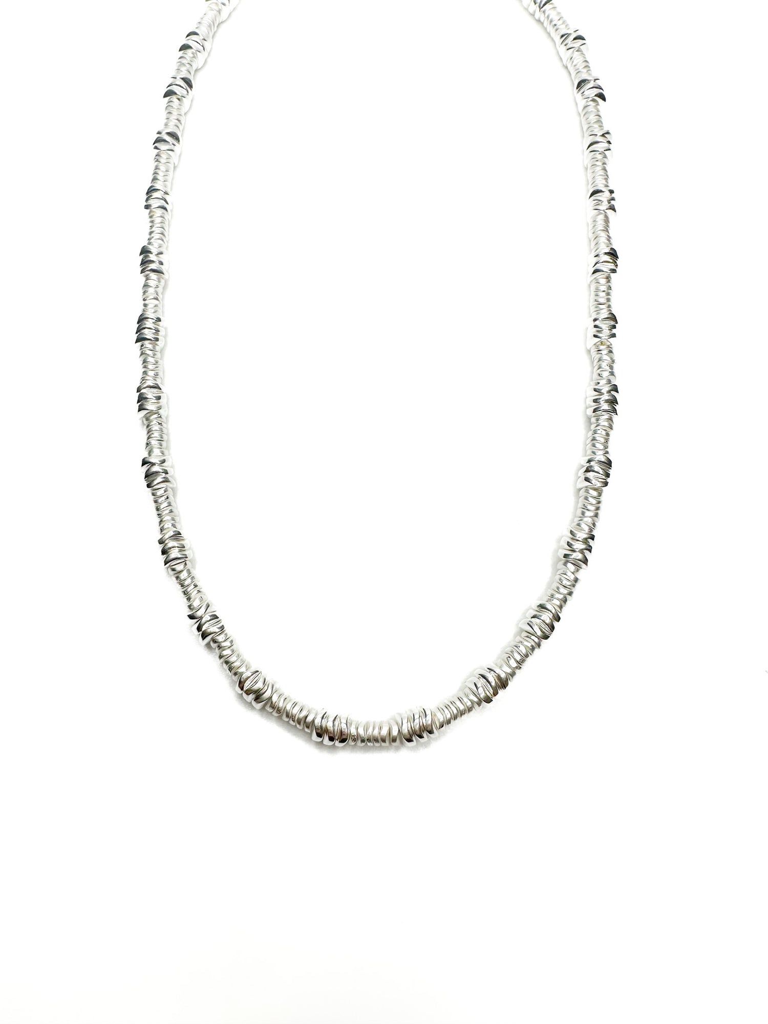 Silver beaded necklace on a white background