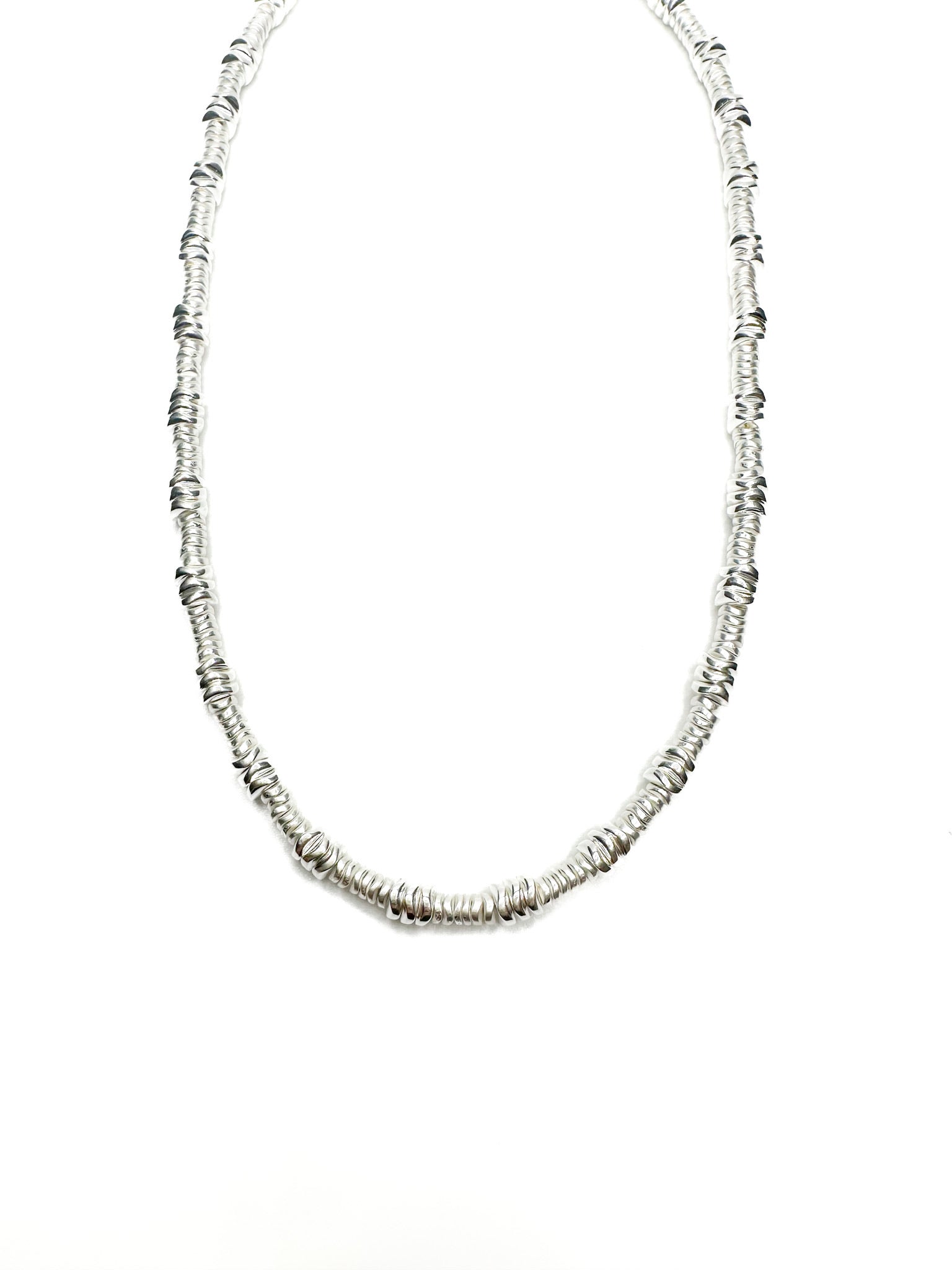 Silver beaded necklace on a white background