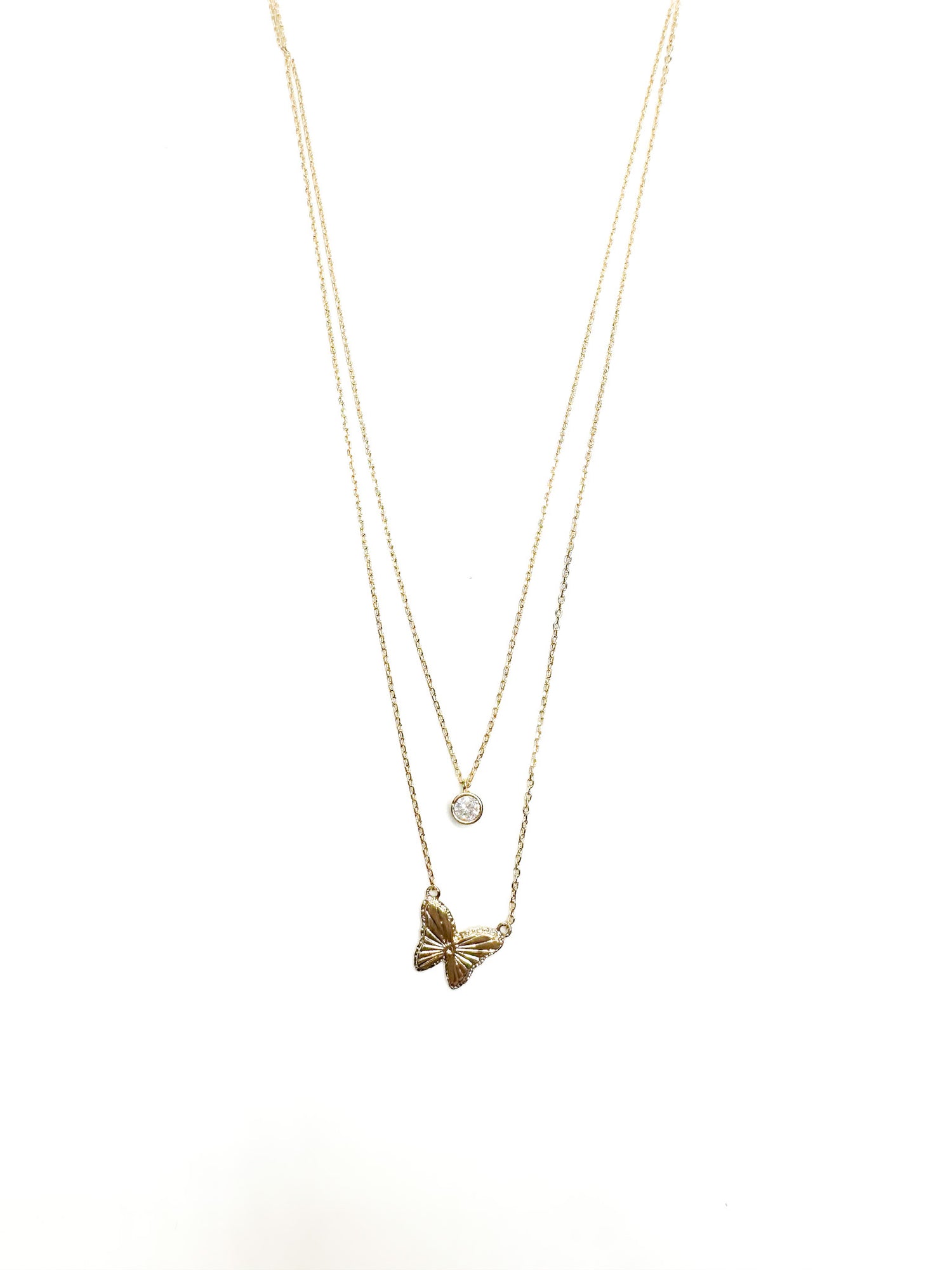 Gold necklace with a bow pendant on a white background