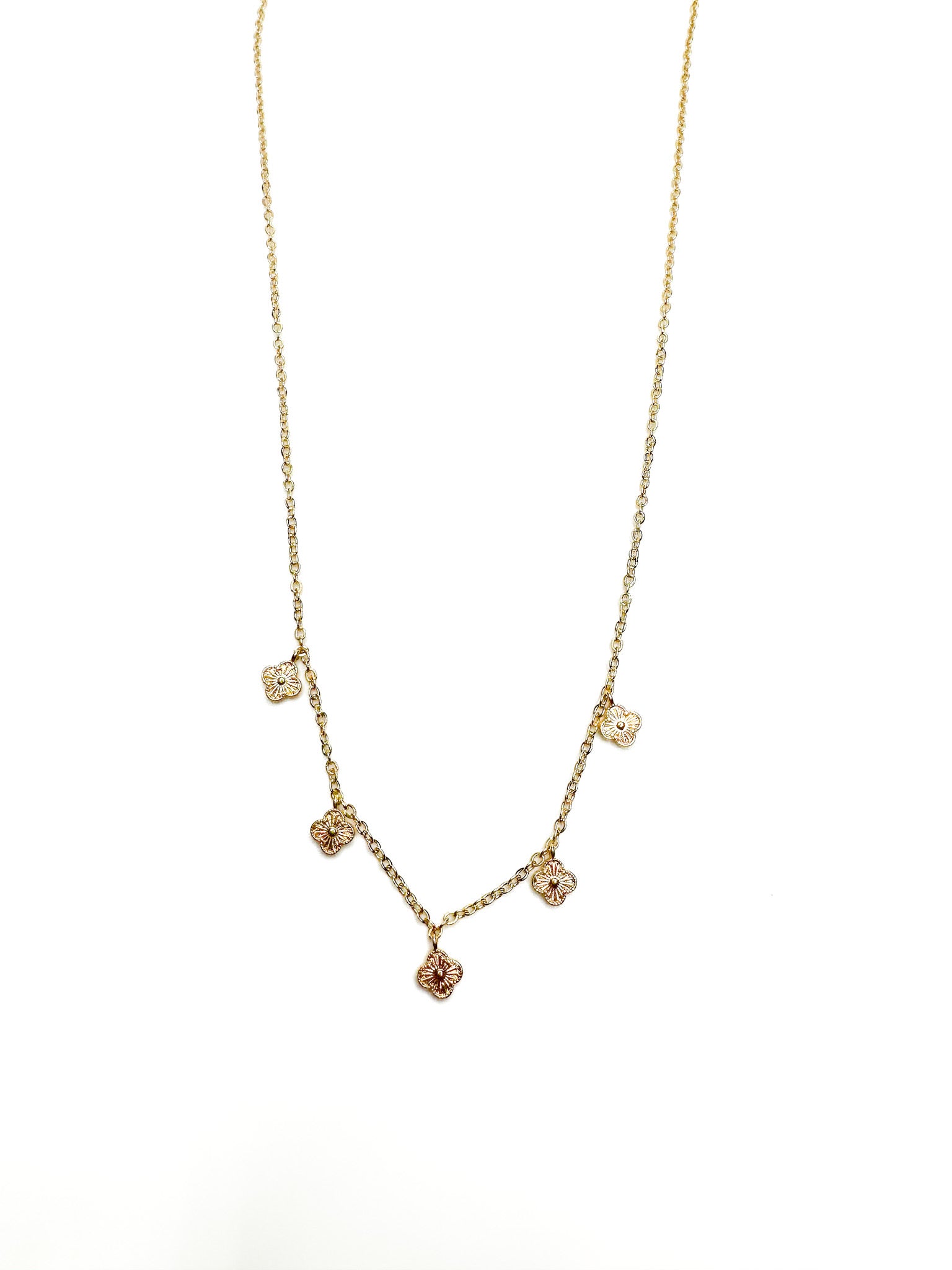 Gold necklace with small round pendants on a white background