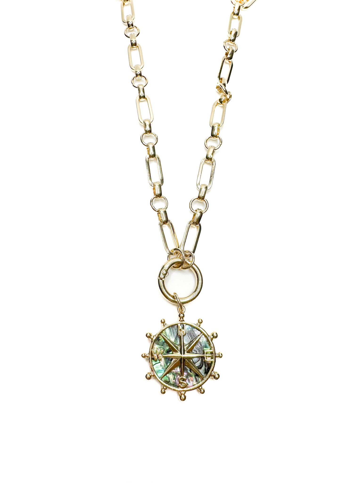 Nautical-style necklace featuring a gold chain and iridescent abalone shell compass pendant