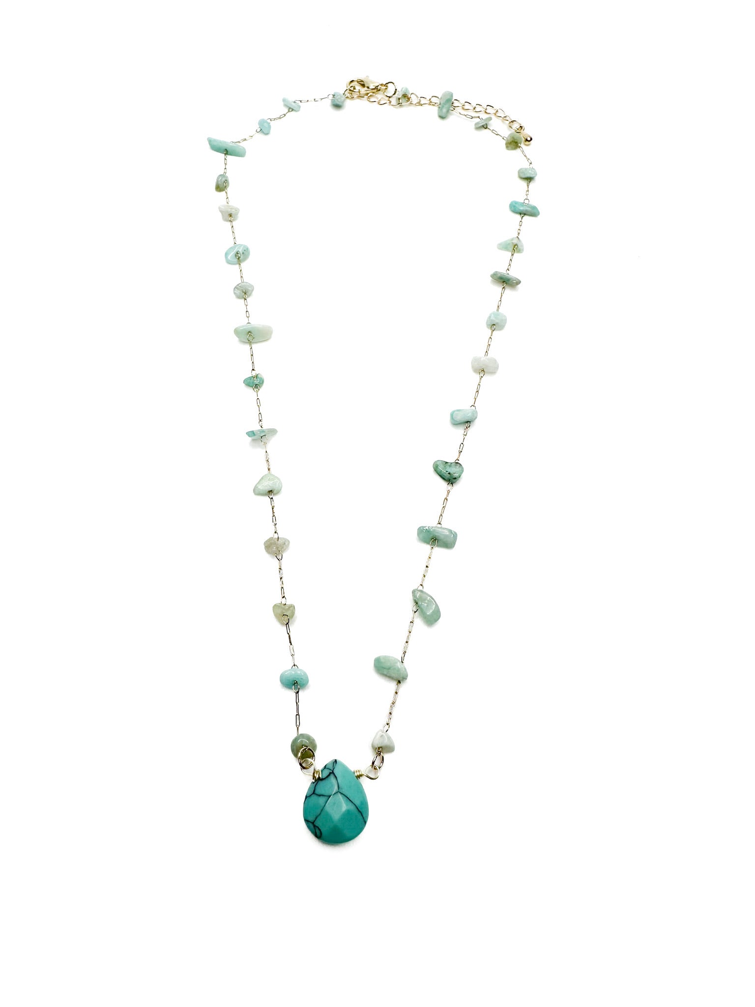 gold-toned necklace with scattered green and turquoise gemstone chips and a large central turquoise teardrop pendant
