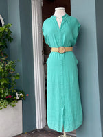 Sharon Dress in turquoise teal linen styled with a woven belt, featuring a split neckline, cap sleeves, midi length, and breathable crinkle texture.
