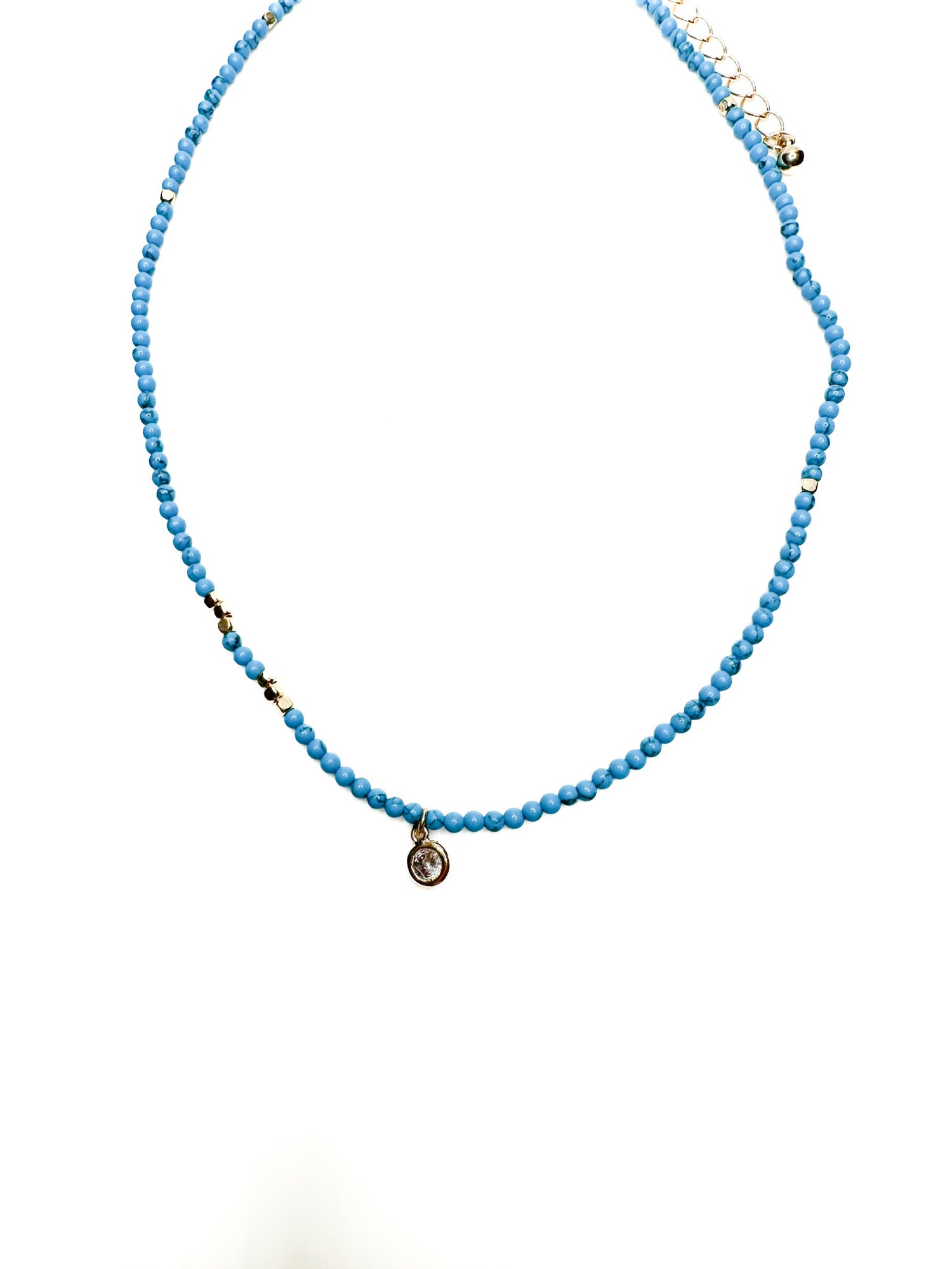 Tessa Necklace with turquoise seed beads, gold accents, and delicate charm at Ardor Boutique.