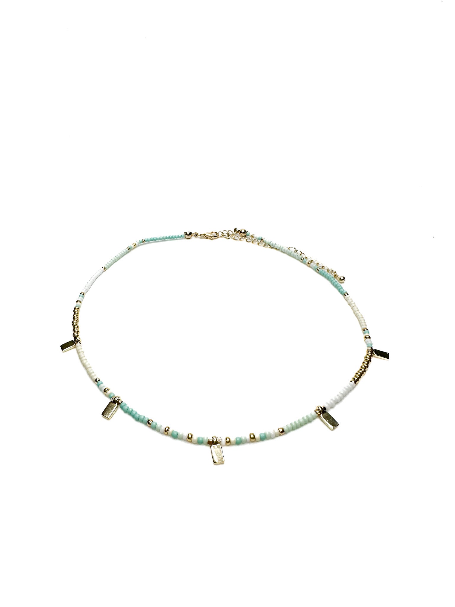Necklace with small beads and petite gold accents on a white background