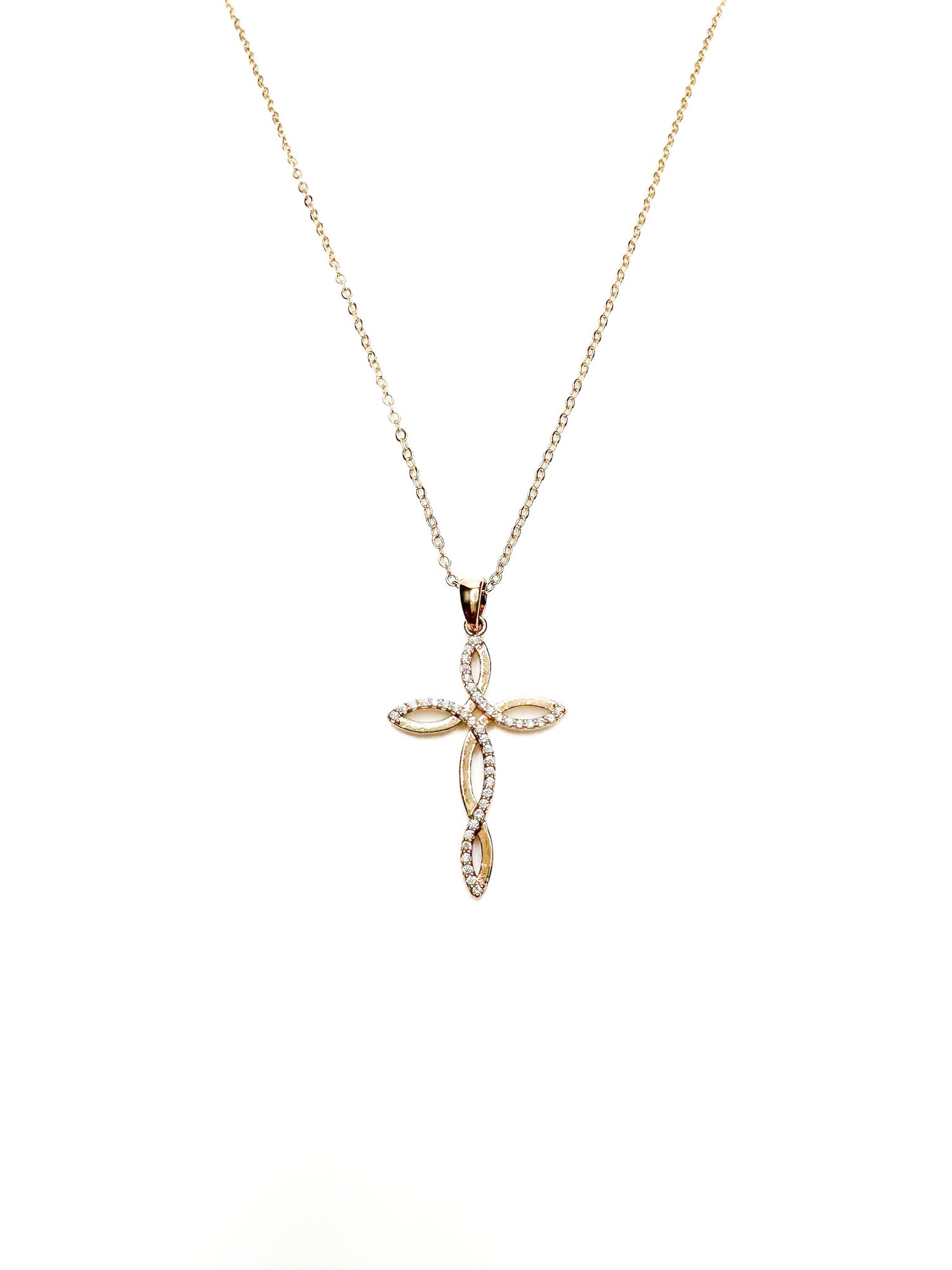 Gold cross pendant necklace on a white background