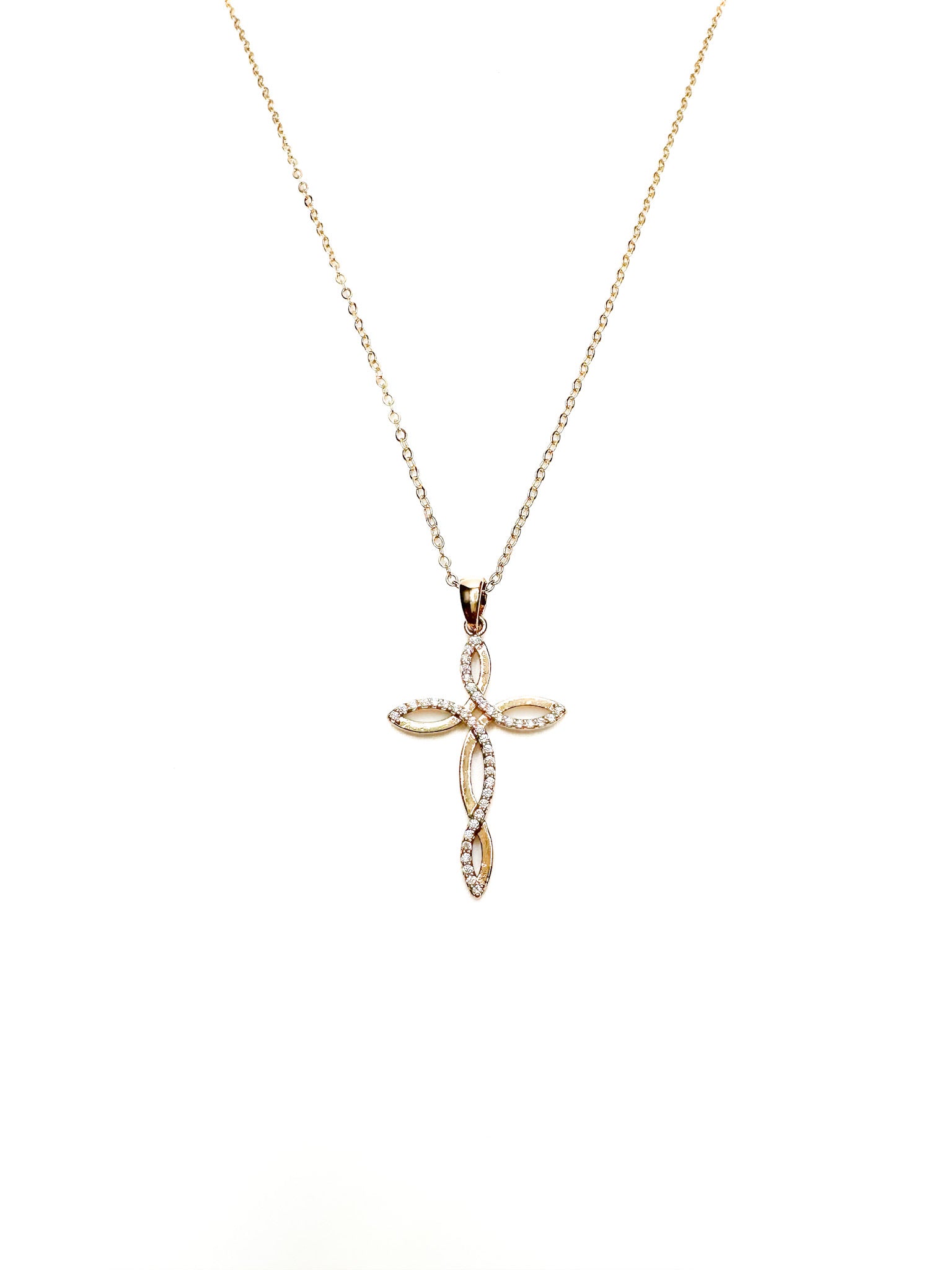 Gold cross pendant necklace on a white background
