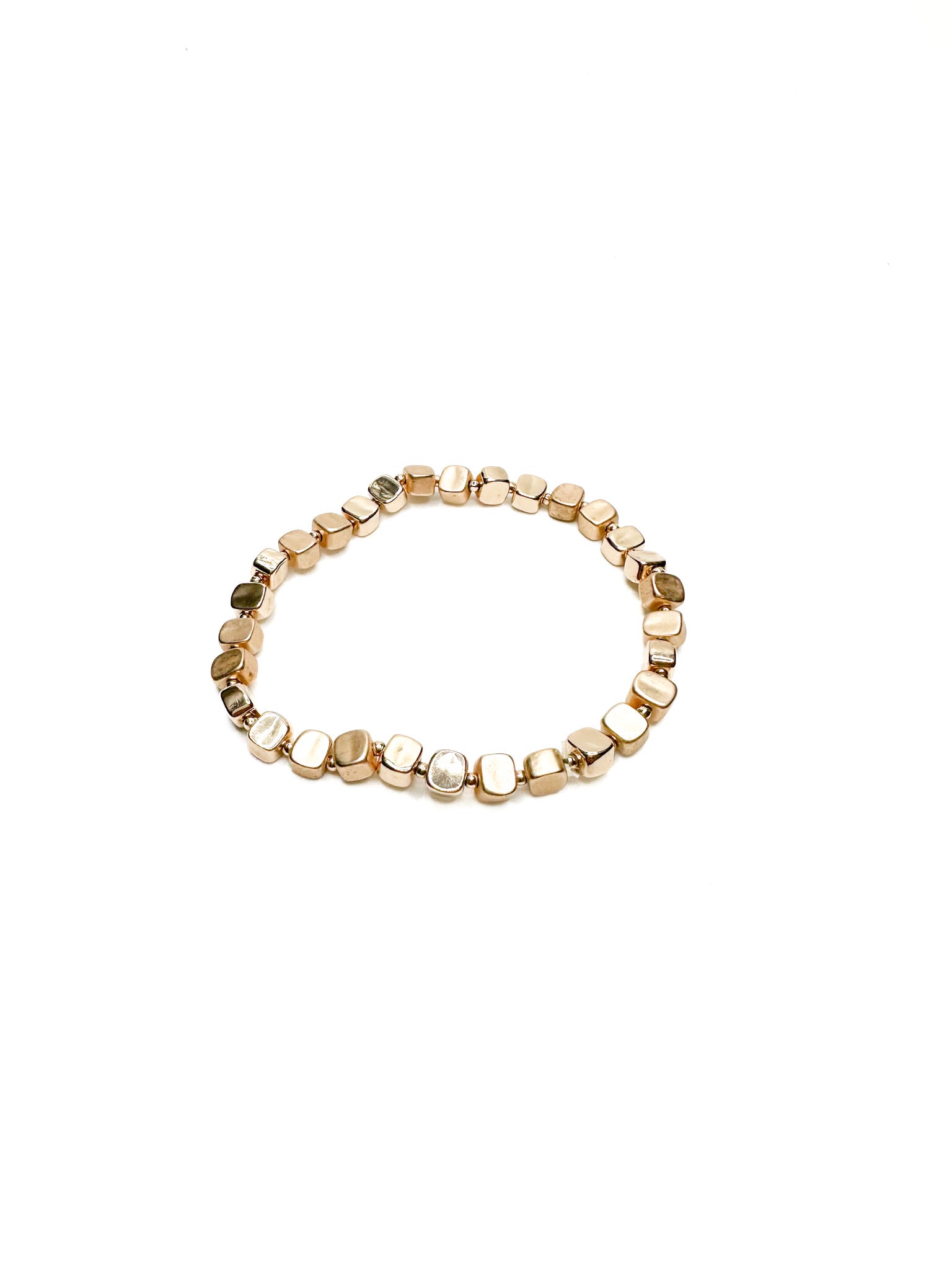 Gold beaded bracelet on a white background