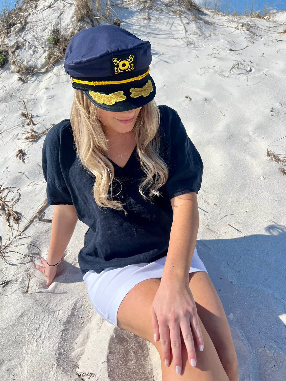 Captain hat on woman in the sand