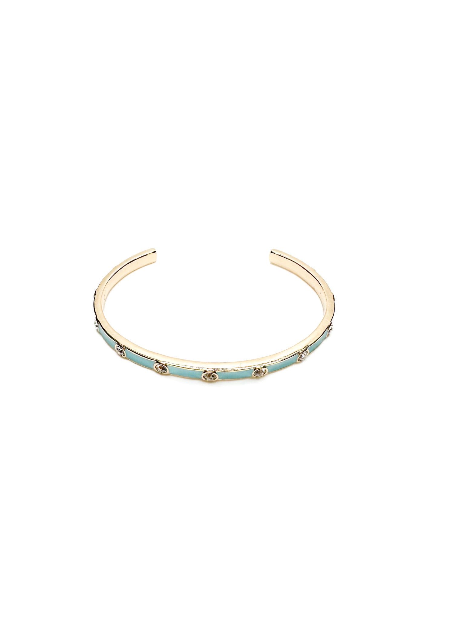 Gold open cuff bracelet with turquoise enamel and clear crystal accents, shown on white background.