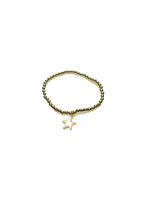 Gold bracelet with a star-shaped charm on a white background