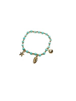 Turquoise beaded bracelet with gold charms on a white background