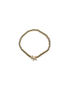 Gold bracelet with a star-shaped charm on a white background