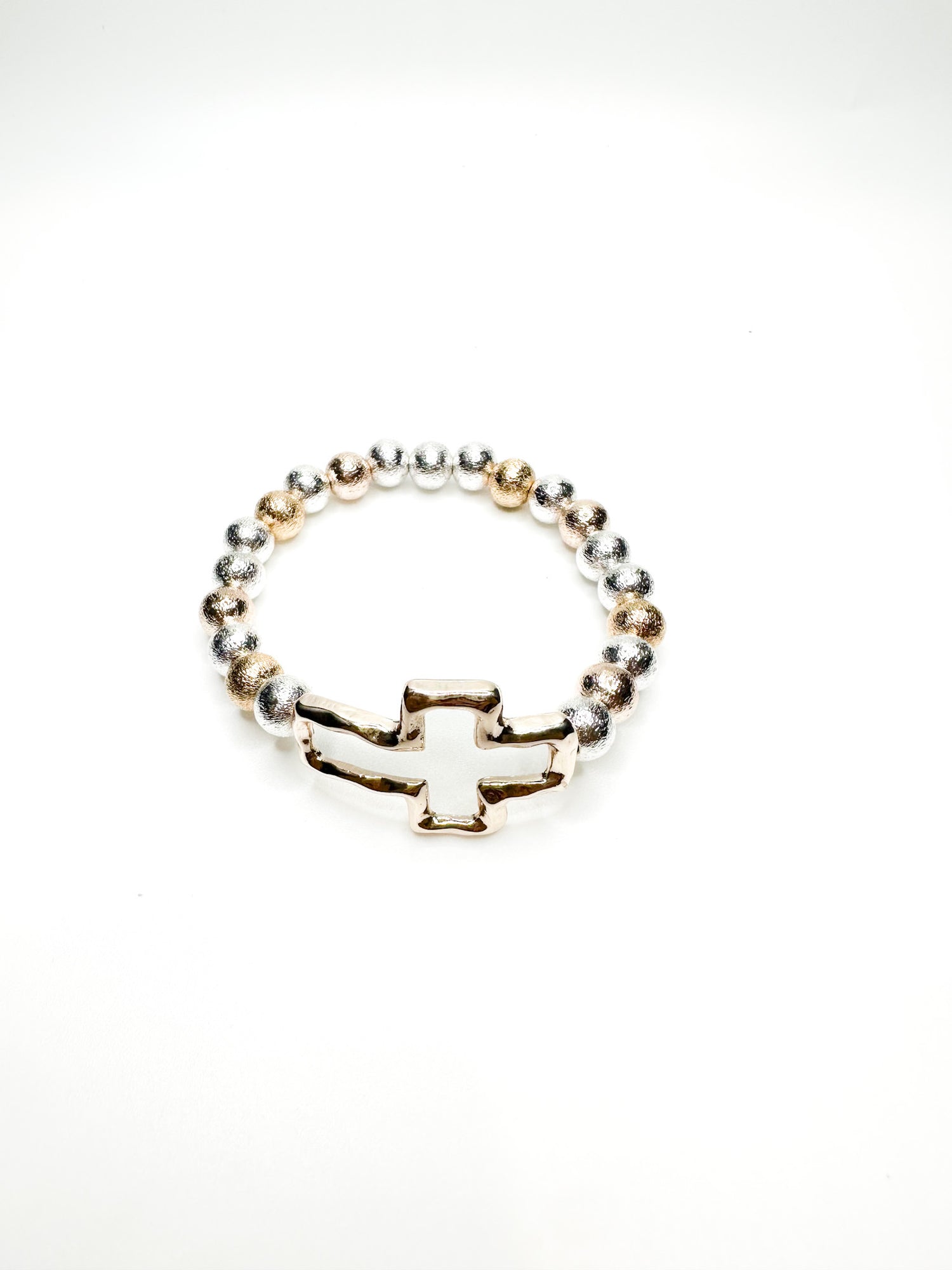Silver and gold beaded stretch bracelet with polished cross charm from Ardor Boutique