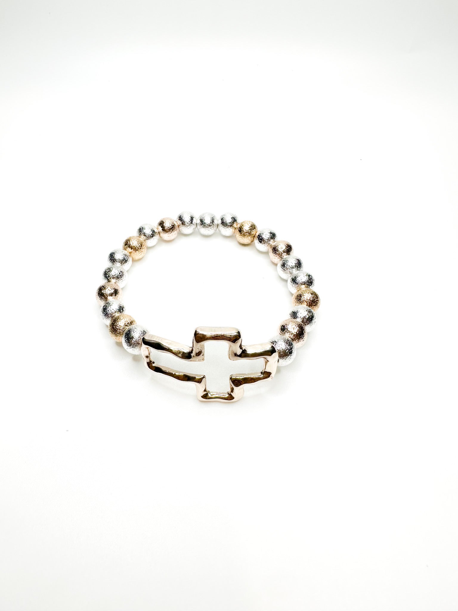 Silver and gold beaded stretch bracelet with polished cross charm from Ardor Boutique