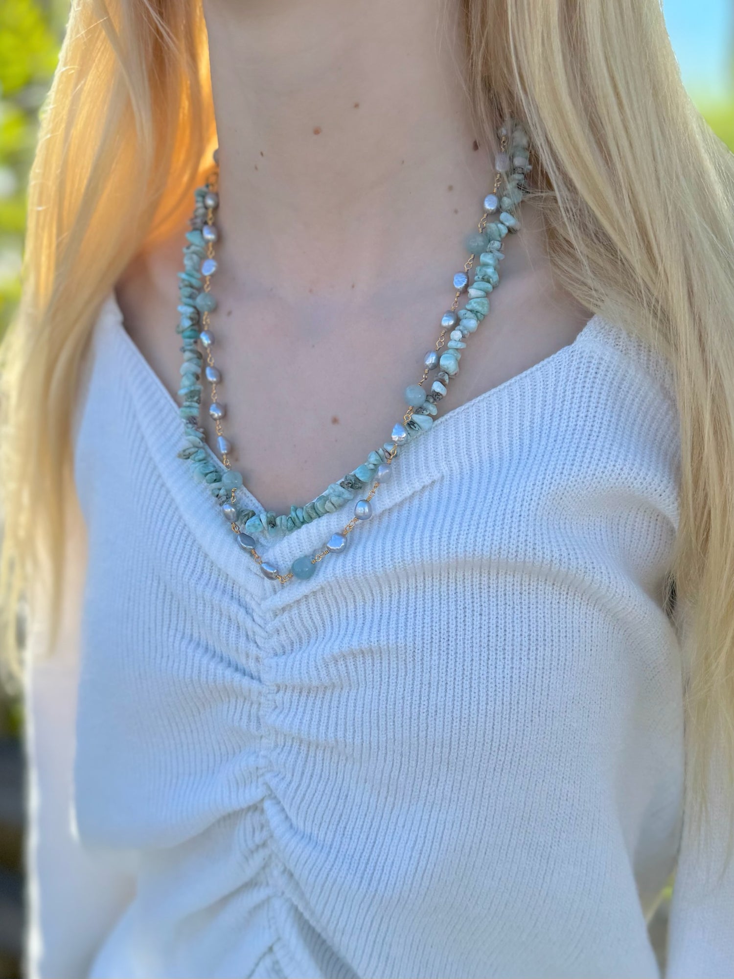necklace featuring amazonite gemstones and freshwater pearls being worn