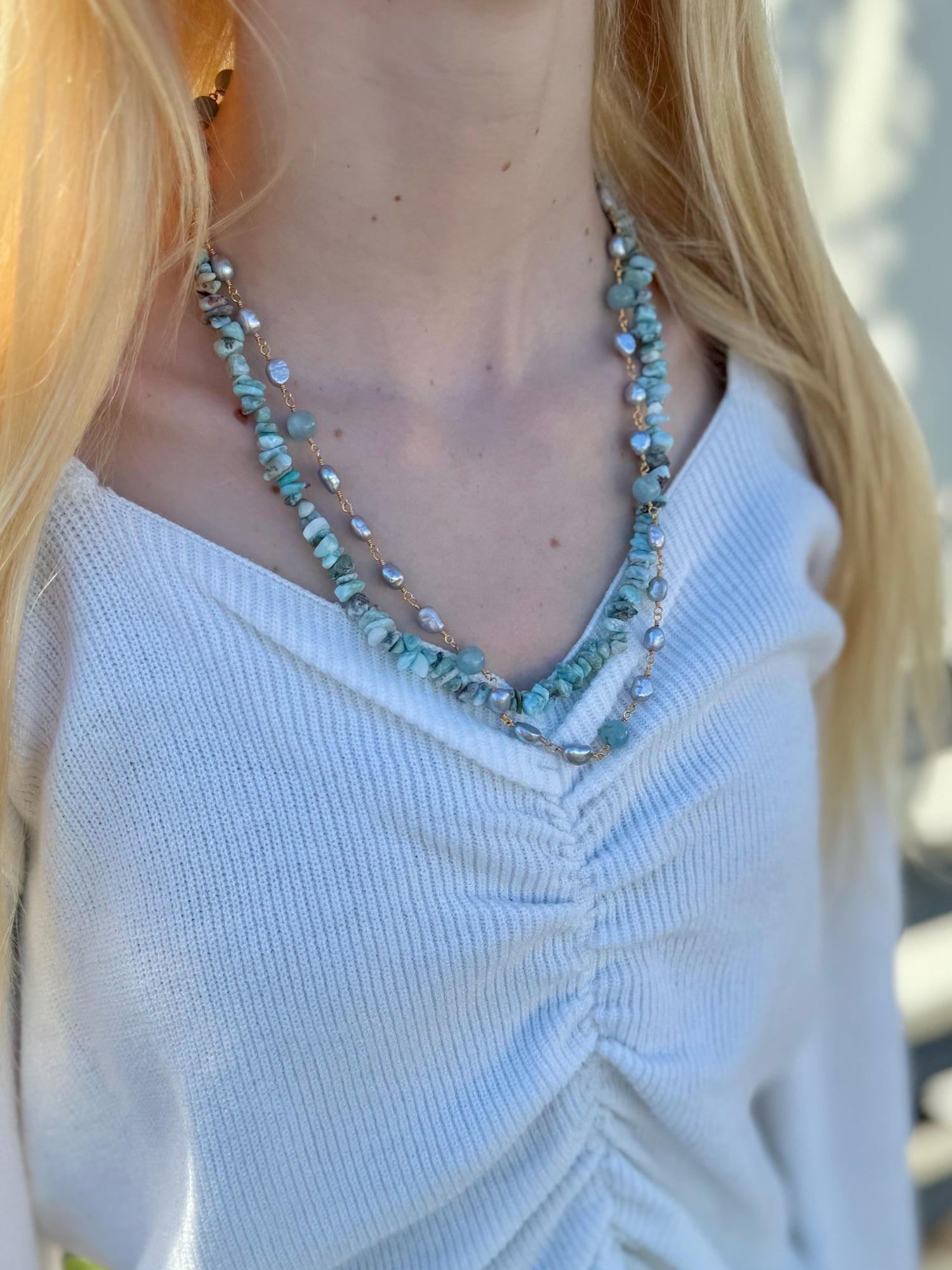 necklace featuring amazonite gemstones and freshwater pearls being worn