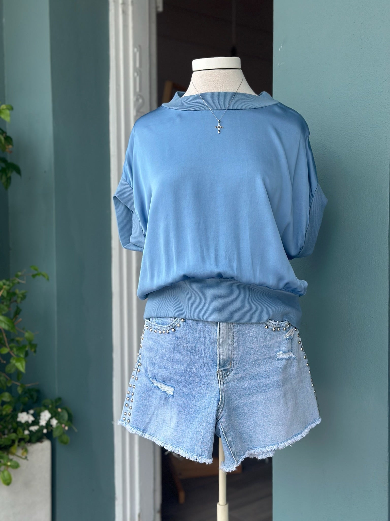 Periwinkle Mara Italian Washable Silk Top with a relaxed draped silhouette, ribbed neckline, cuffed short sleeves, and a polished, silky finish.
