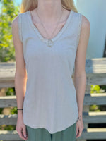 Front view of beige sequin-trim tank with V-neckline and soft knit fabric.