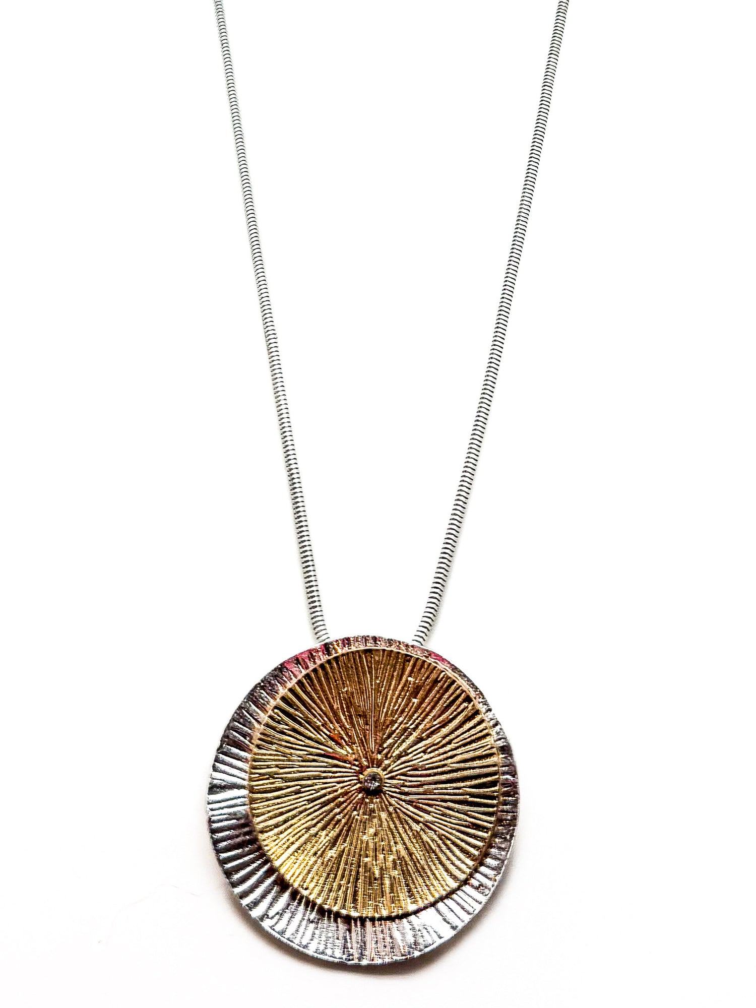 Mixed-metal sunburst pendant on a 32-inch silver chain, the Solene Necklace at Ardor Boutique 