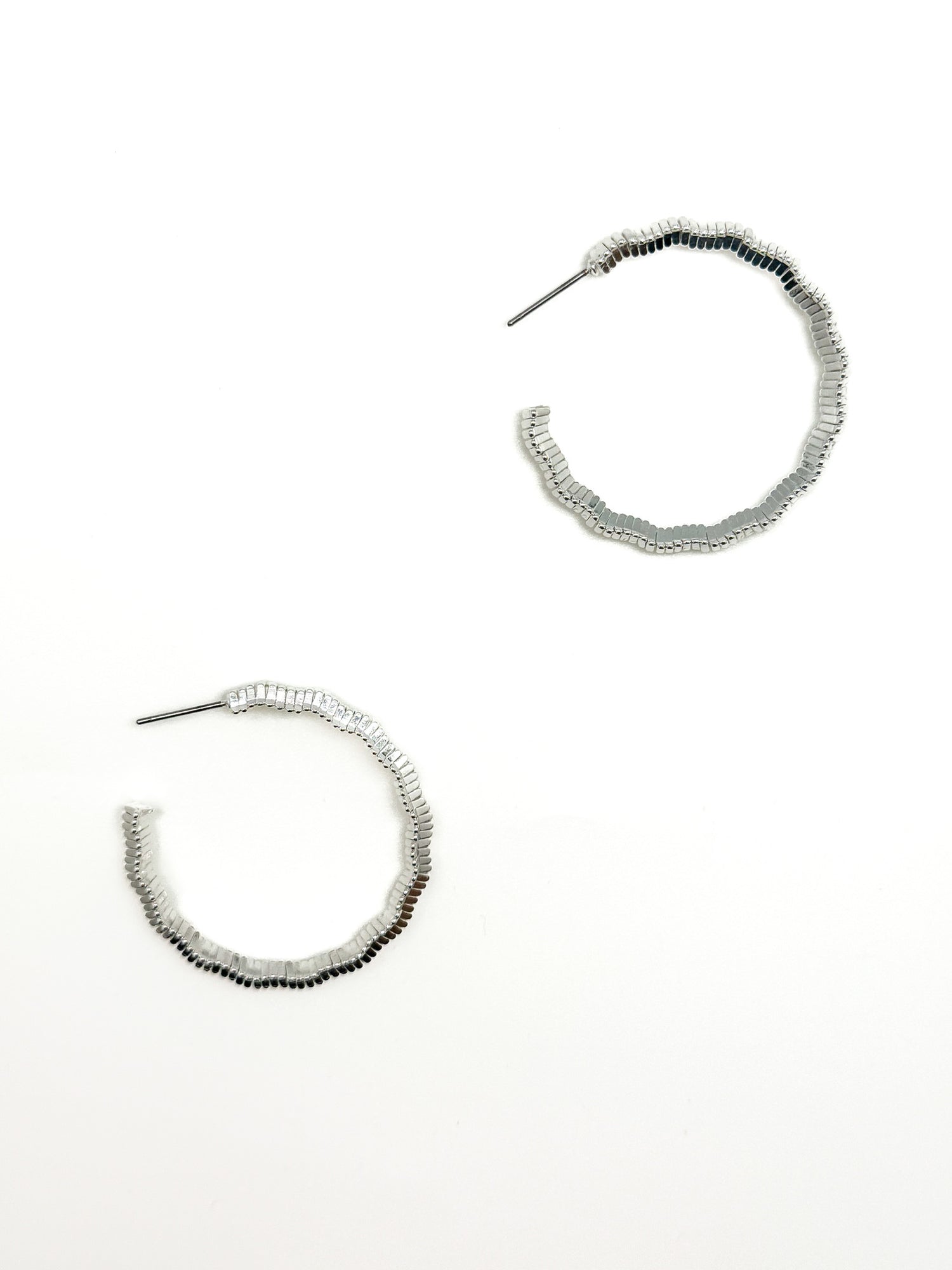 Silver hoop earrings on a white background