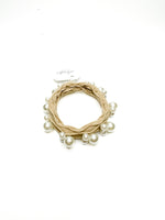 Beige wreath with pearls on a white background