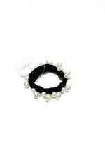 Black hair tie with pearls on a white background