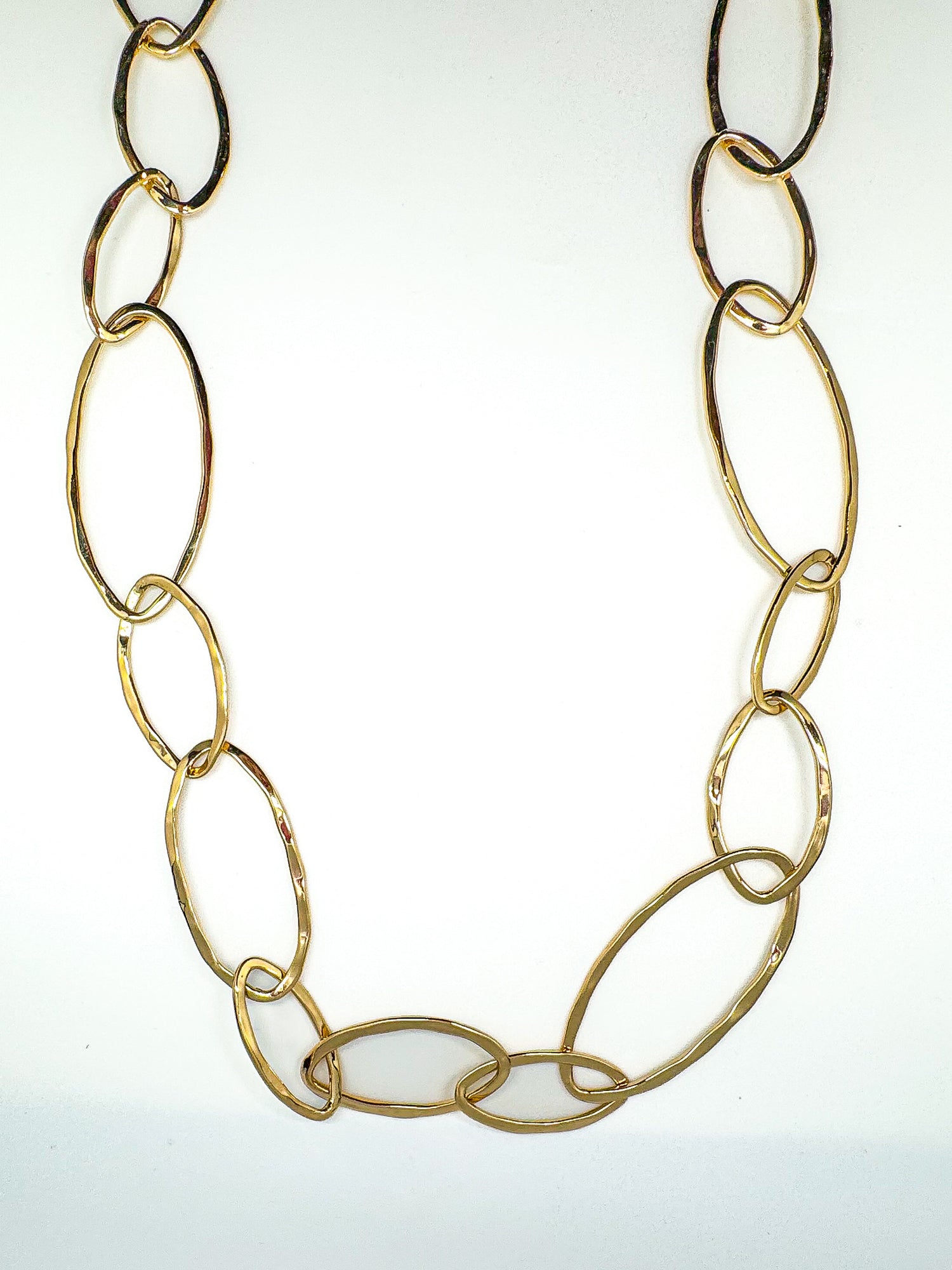 Gold chain necklace on a white background
