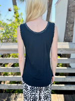 Back of a person wearing a black sleeveless top with sparkly trim 