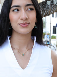 Aqua crystal rondel necklace on model paired with earrings from the nh Aqua gold collection 