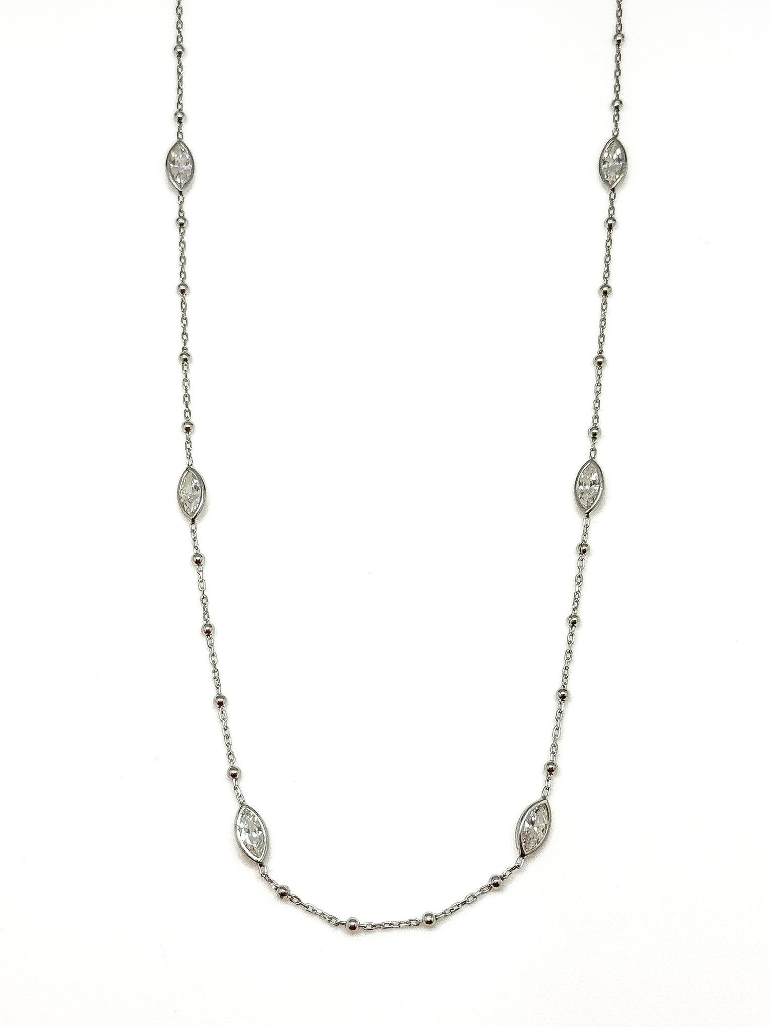 Sterling silver station necklace with marquise-shaped accents photographed on a white background