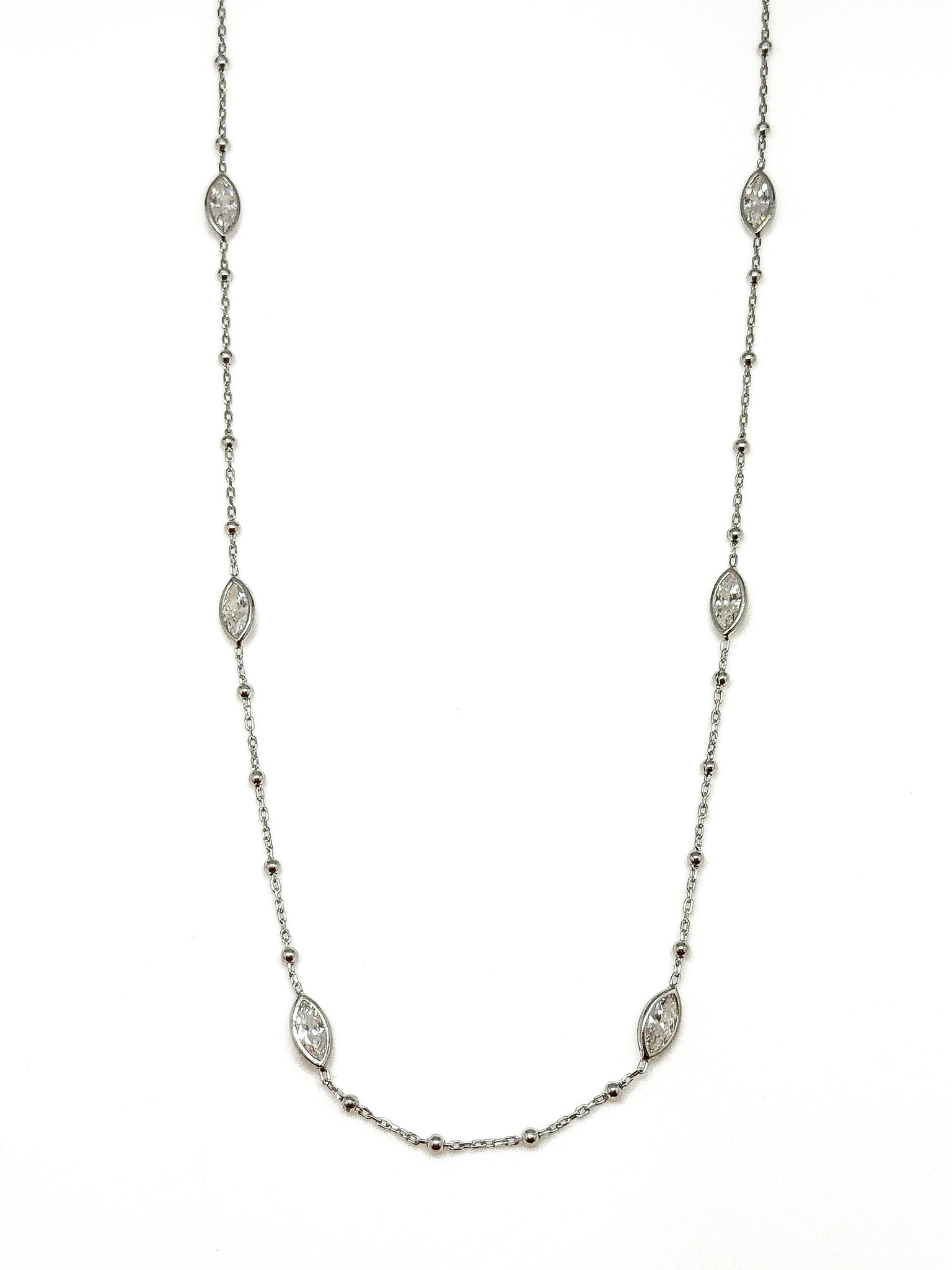 Sterling silver station necklace with marquise-shaped accents photographed on a white background