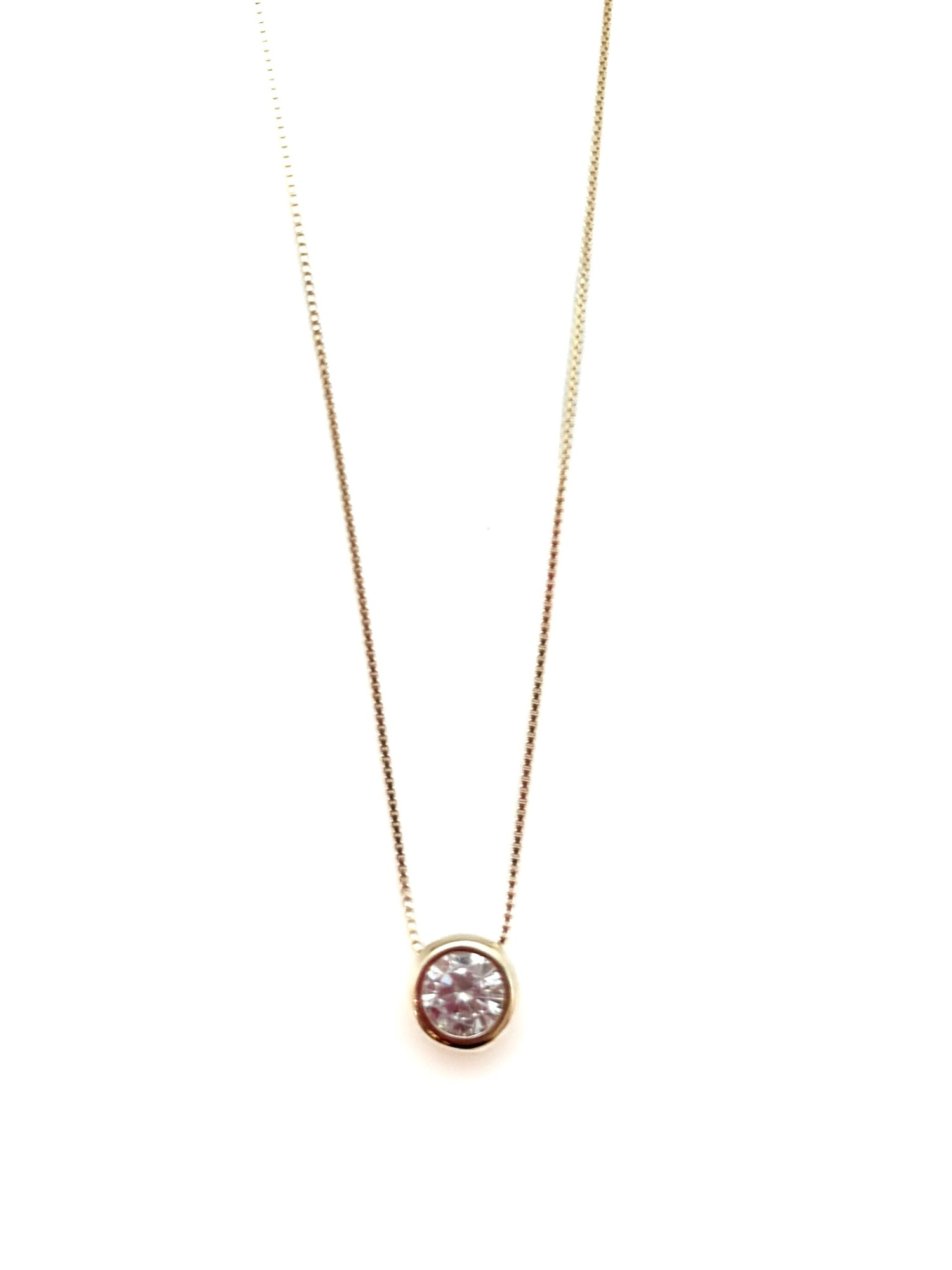 Gold necklace with a round pendant on a white background